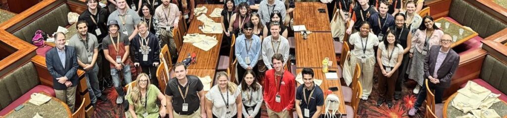 2024 Toronto Metropolitan University Thrill Design Competition participant group photo: about 125 people are seen in Universal CityWalk Rising Star in photo taken from balcony.