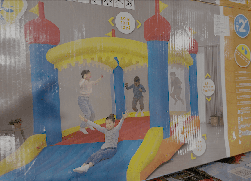 box illustration from consumer grade inflatable in warehouse store. four well-spaced and similarly sized children bounce in a yellow, blue, and red bouncy house