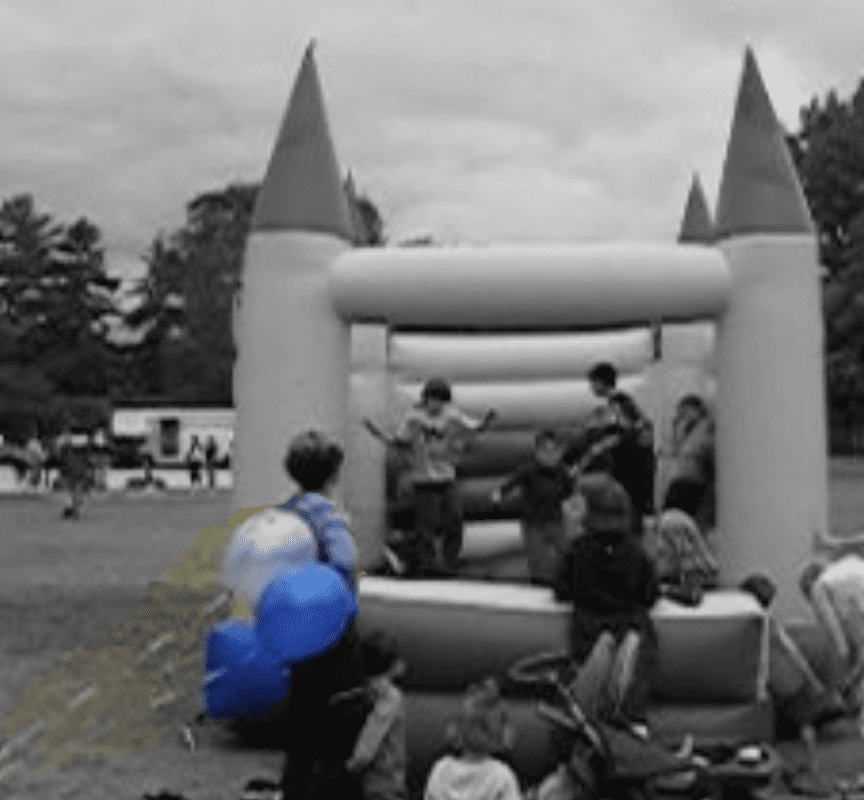 Desaturated image of all but balloons, showing the wind picking up but no one appears to notice.
